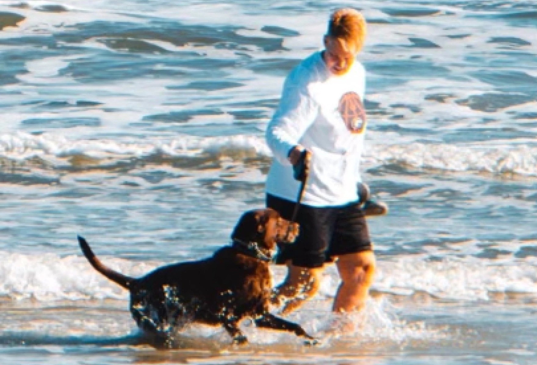 Photo of Mary Roach and Jaxon running on the beach