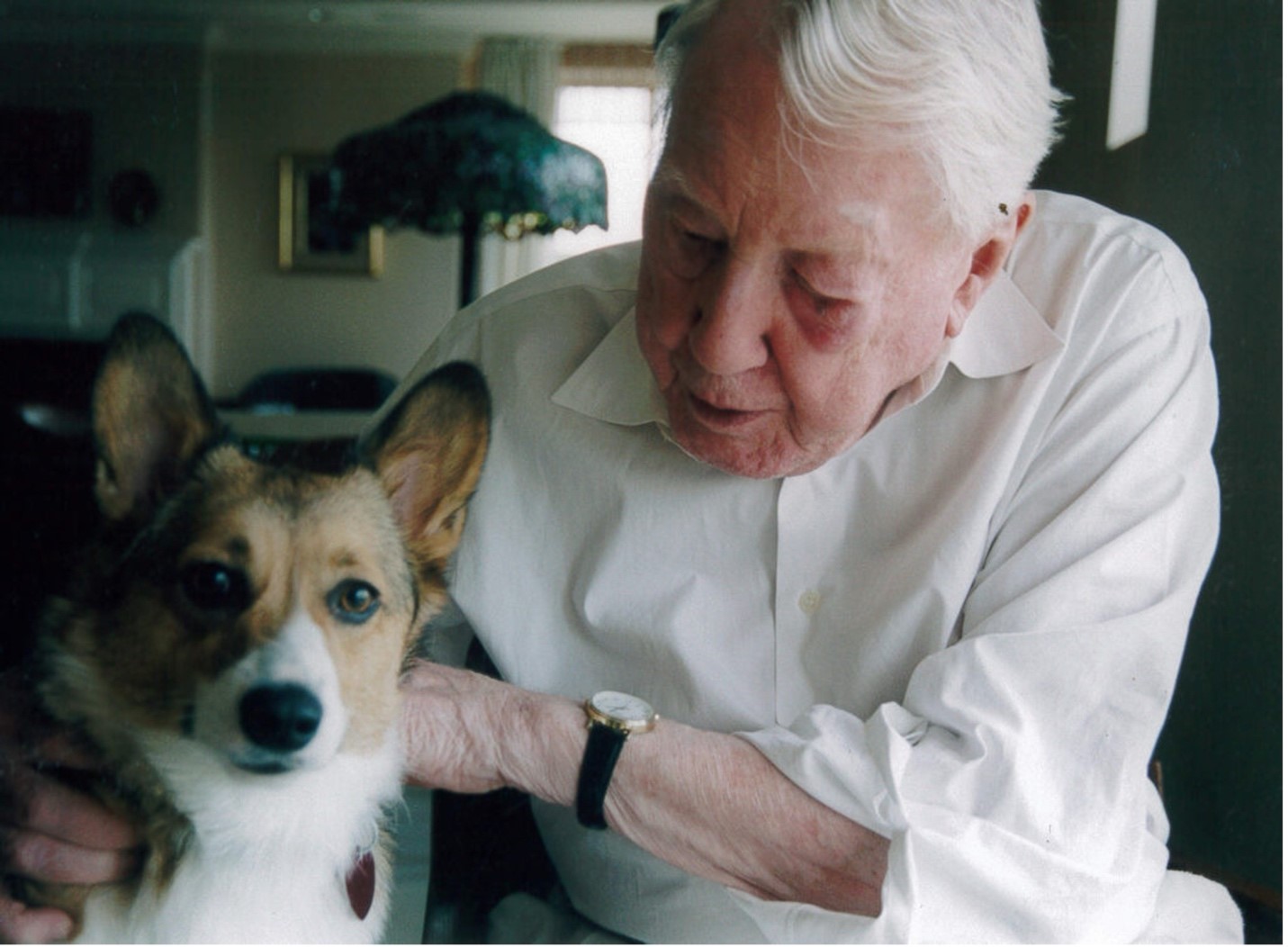 Photo of Frank Stanton petting his dog, Annie