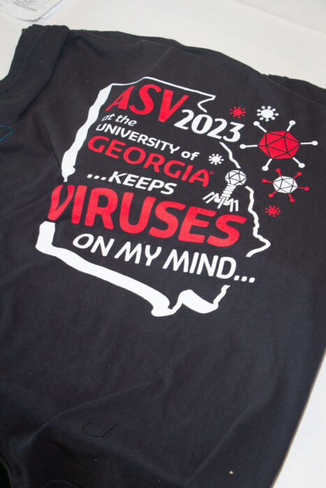 A t-shirt with text stating "ASV 2023 at the University of Georgia keeps Viruses on my mind"